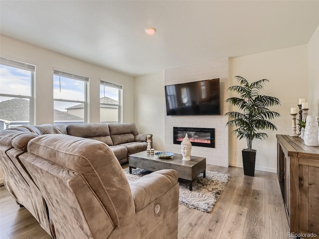 4955 Trails Edge Ln, Castle Rock, CO 80104 - living area featuring wood finished floors, a fireplace, and baseboards