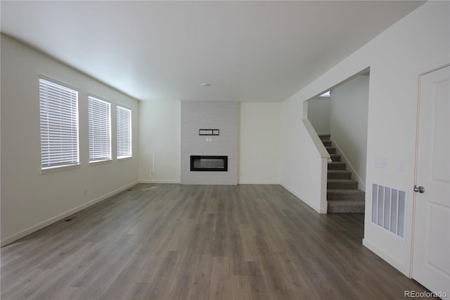 4955 Trails Edge Ln, Castle Rock, CO 80104 - unfurnished living room featuring wood finished floors, baseboards, and stairs
