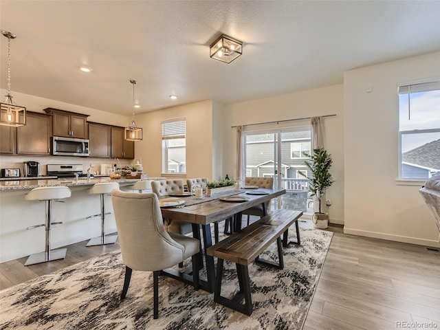 4955 Trails Edge Ln, Castle Rock, CO 80104 - dining area with plenty of natural light, recessed lighting, light wood-style floors, and baseboards
