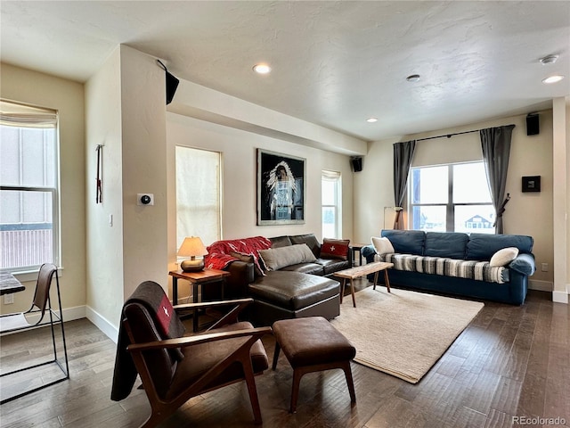 living room with dark wood-type flooring, recessed lighting, and baseboards