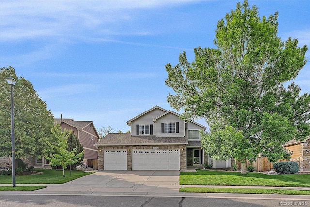 10723 W 54th Pl, Arvada, CO 80002 - view of front facade with concrete driveway, a front yard, and a garage