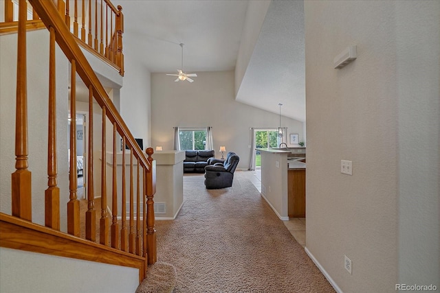 10723 W 54th Pl, Arvada, CO 80002 - hallway featuring light carpet, vaulted ceiling, stairway, and a sink
