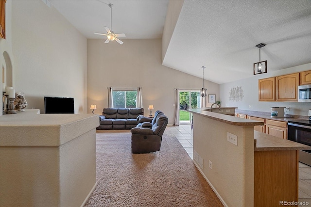 10723 W 54th Pl, Arvada, CO 80002 - kitchen featuring appliances with stainless steel finishes, ceiling fan, a center island with sink, light countertops, and pendant lighting