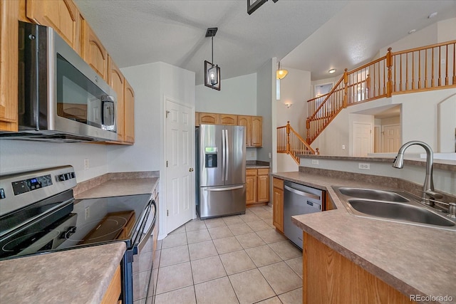 10723 W 54th Pl, Arvada, CO 80002 - kitchen with appliances with stainless steel finishes, a sink, lofted ceiling, light tile patterned flooring, and pendant lighting