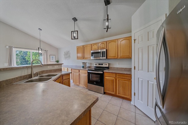 10723 W 54th Pl, Arvada, CO 80002 - kitchen with stainless steel appliances, a sink, lofted ceiling, light tile patterned floors, and decorative light fixtures