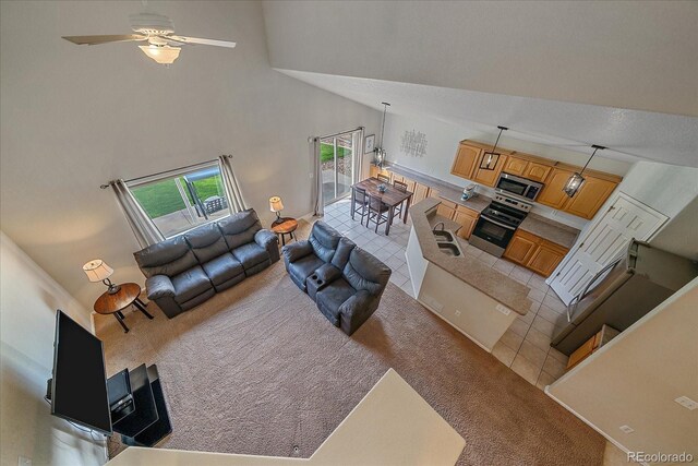 10723 W 54th Pl, Arvada, CO 80002 - living room with light colored carpet, a ceiling fan, and a towering ceiling