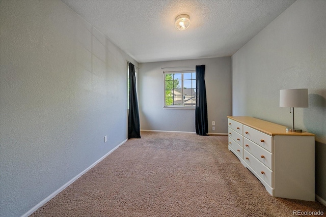 10723 W 54th Pl, Arvada, CO 80002 - unfurnished bedroom featuring a textured ceiling, a textured wall, light colored carpet, and baseboards