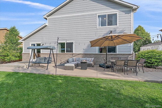 10723 W 54th Pl, Arvada, CO 80002 - back of house featuring a lawn, a patio area, and brick siding