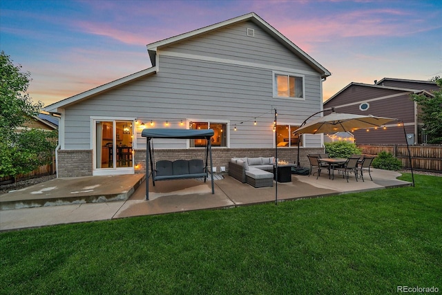 10723 W 54th Pl, Arvada, CO 80002 - back of house featuring brick siding, a patio area, and an outdoor hangout area
