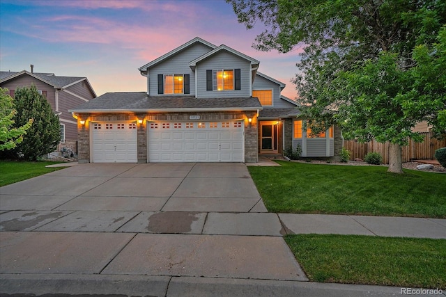 10723 W 54th Pl, Arvada, CO 80002 - traditional home with driveway, stone siding, and a garage