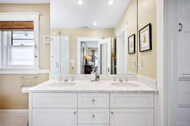 bathroom featuring vanity, plenty of natural light, and walk in shower