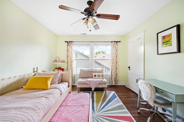 bedroom with ceiling fan and dark hardwood / wood-style floors