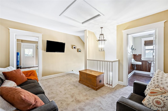 living room featuring lofted ceiling and light carpet