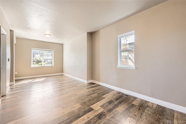 3225 Olive St, Denver, CO 80207 - empty room with wood finished floors and baseboards