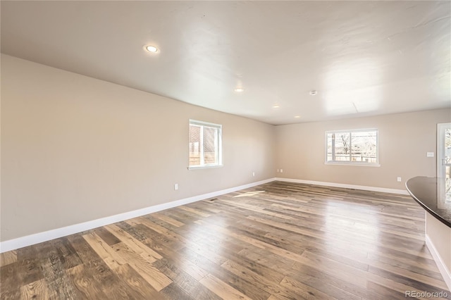 3225 Olive St, Denver, CO 80207 - empty room with plenty of natural light, baseboards, wood finished floors, and recessed lighting