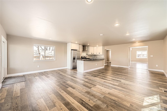 3225 Olive St, Denver, CO 80207 - unfurnished living room with wood finished floors, a sink, recessed lighting, and baseboards