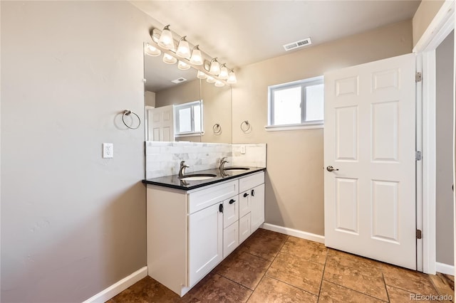 3225 Olive St, Denver, CO 80207 - full bathroom featuring decorative backsplash, baseboards, and double vanity