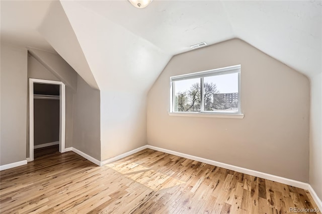 3225 Olive St, Denver, CO 80207 - additional living space featuring wood finished floors, vaulted ceiling, and baseboards