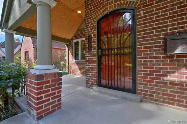 view of exterior entry featuring a porch