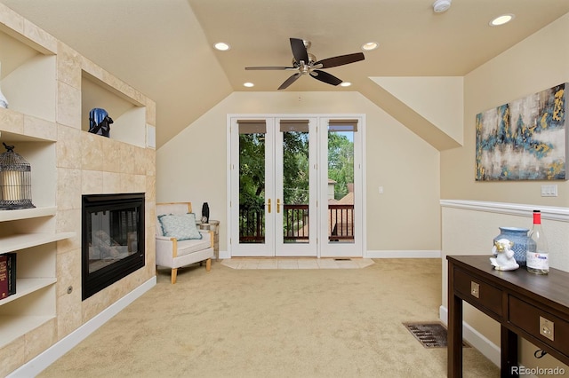 sitting room with a fireplace, vaulted ceiling, carpet floors, built in features, and ceiling fan