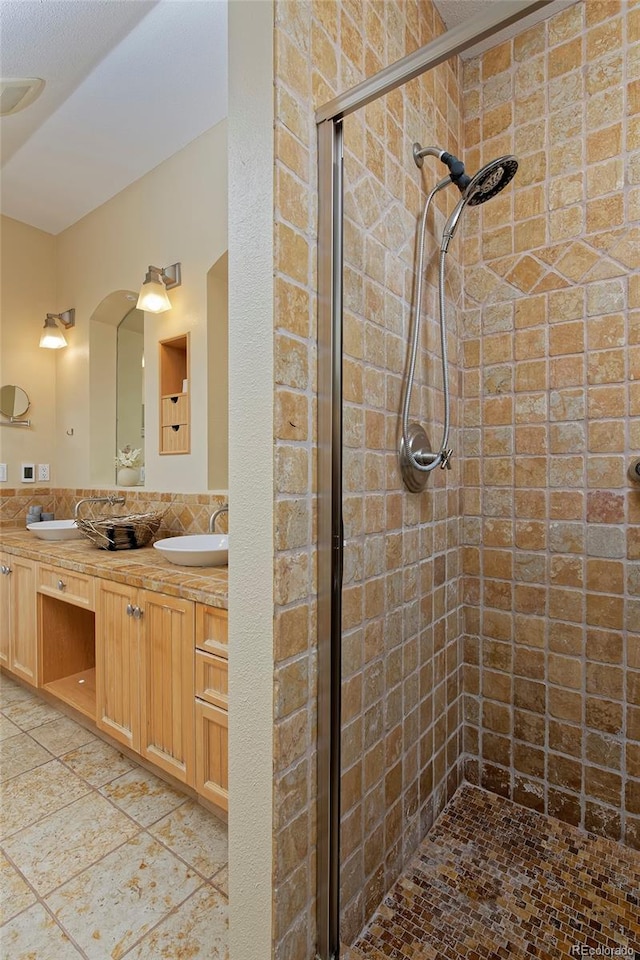 bathroom featuring vanity and an enclosed shower