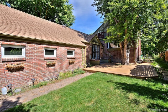 exterior space featuring a lawn and a deck