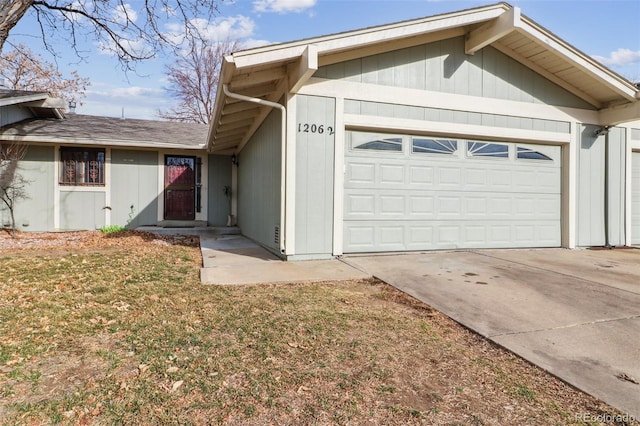 ranch-style home with a garage and driveway