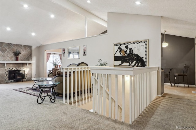 interior space featuring an upstairs landing, carpet flooring, recessed lighting, and lofted ceiling with beams