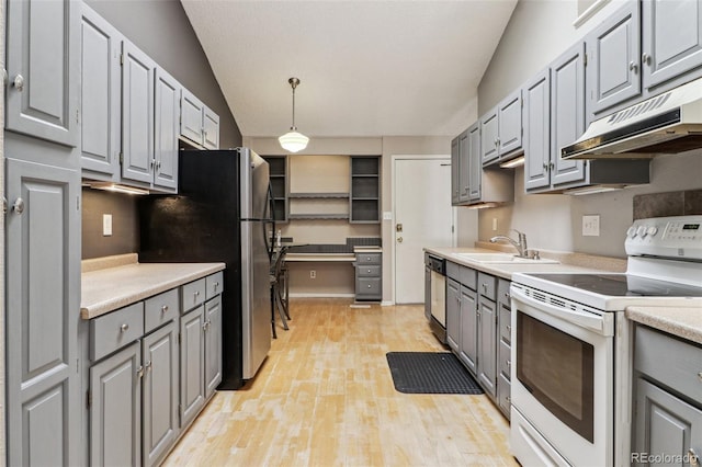 kitchen with gray cabinetry, under cabinet range hood, and stainless steel appliances