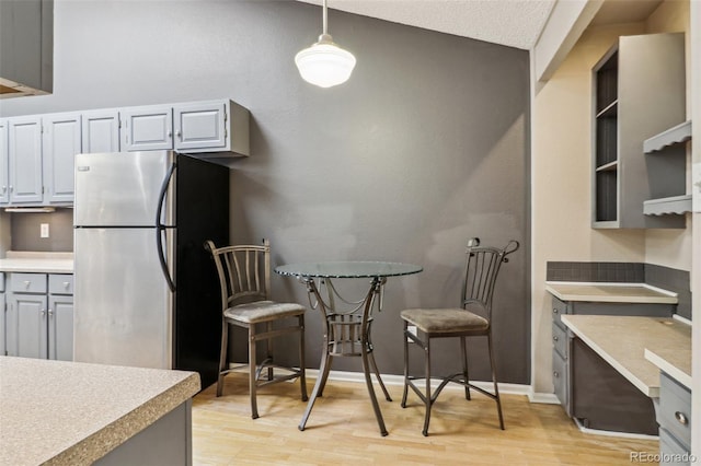 dining room with baseboards and light wood finished floors