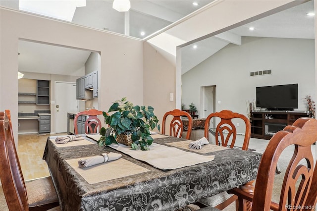 dining space with recessed lighting, beamed ceiling, high vaulted ceiling, and visible vents