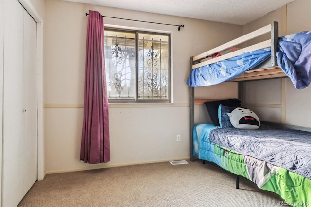 carpeted bedroom with visible vents and baseboards