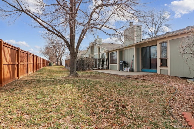 view of yard featuring a patio area and a fenced backyard