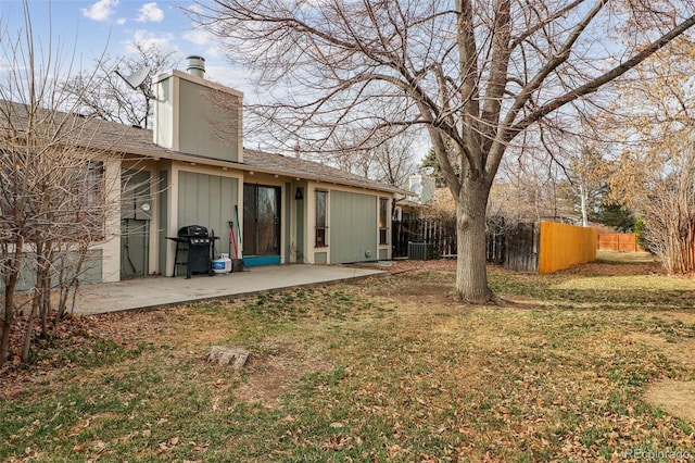 view of yard featuring a patio area, central air condition unit, and fence