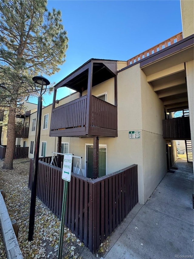 view of home's exterior with a balcony