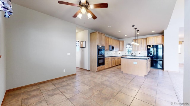 kitchen featuring black appliances, sink, a kitchen island, light brown cabinets, and decorative light fixtures