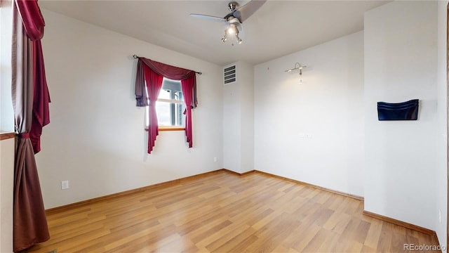 empty room with light hardwood / wood-style floors and ceiling fan