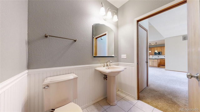 bathroom featuring toilet and tile patterned floors