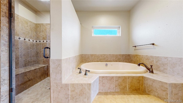 bathroom featuring tile patterned flooring and separate shower and tub