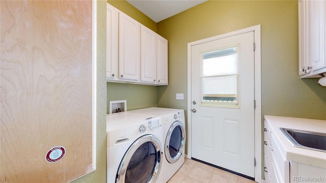 washroom with washing machine and dryer, cabinets, sink, and light tile patterned flooring