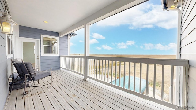 wooden deck featuring a swimming pool