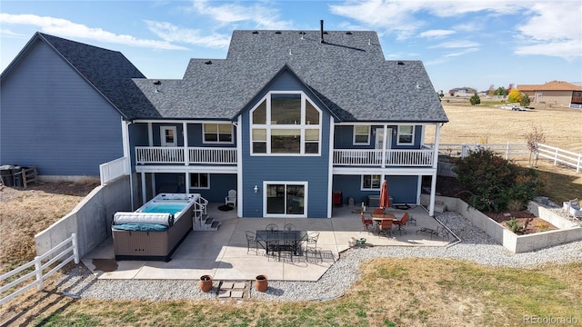 rear view of property with a patio and a balcony