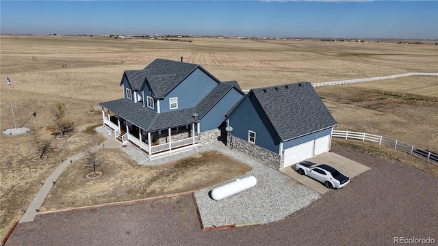 birds eye view of property with a rural view