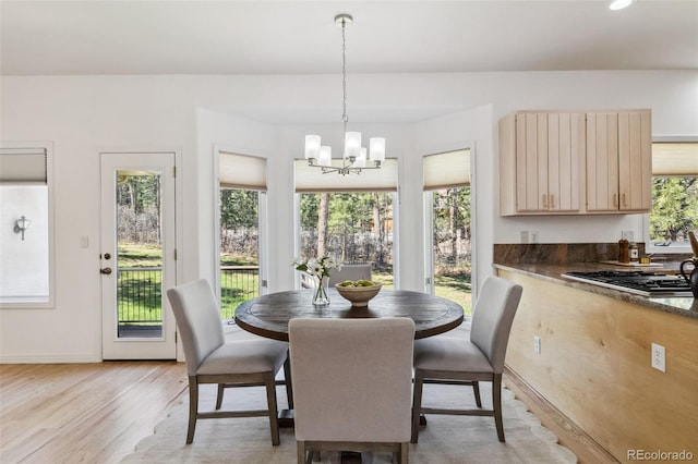 dining space with healthy amount of natural light, a chandelier, light wood-type flooring, baseboards, and recessed lighting