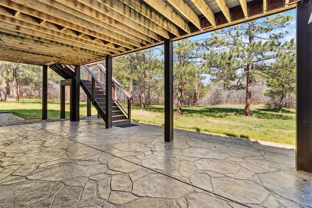 view of patio with stairway and view of wooded area