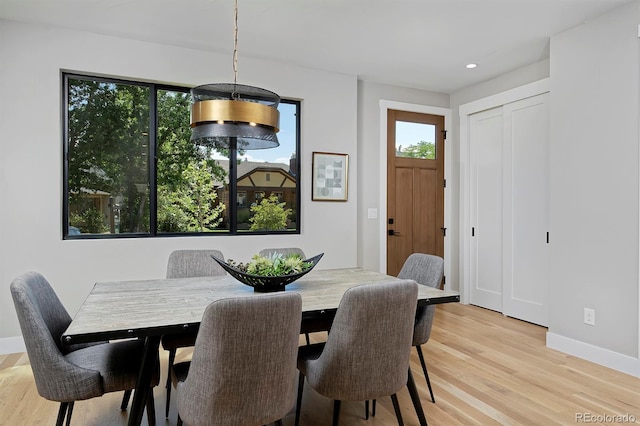 dining space with light hardwood / wood-style floors