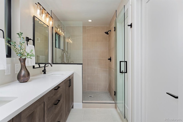 bathroom with vanity, a shower with shower door, and tile patterned flooring