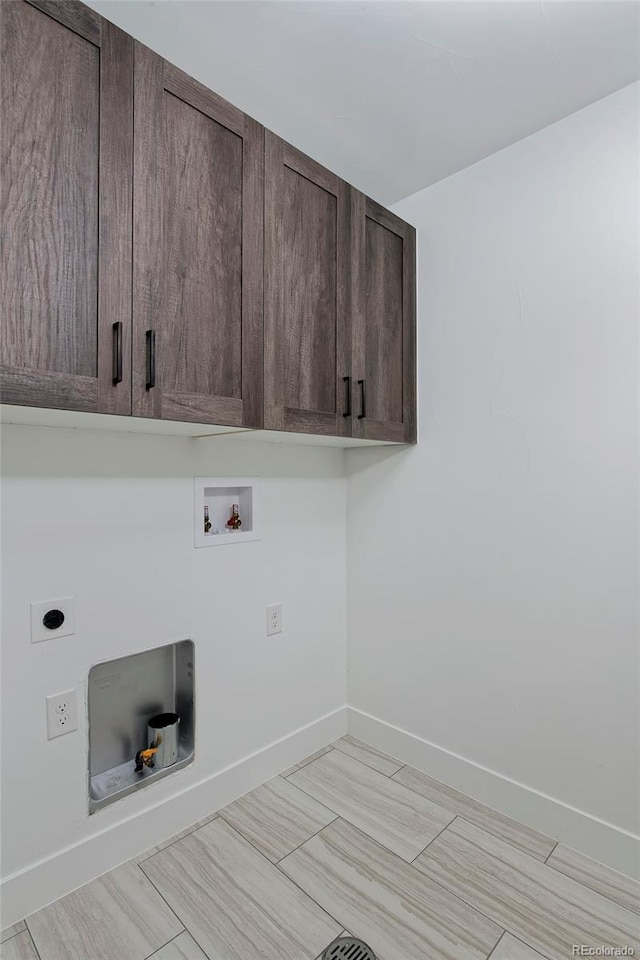 laundry room with cabinets, hookup for an electric dryer, and hookup for a washing machine