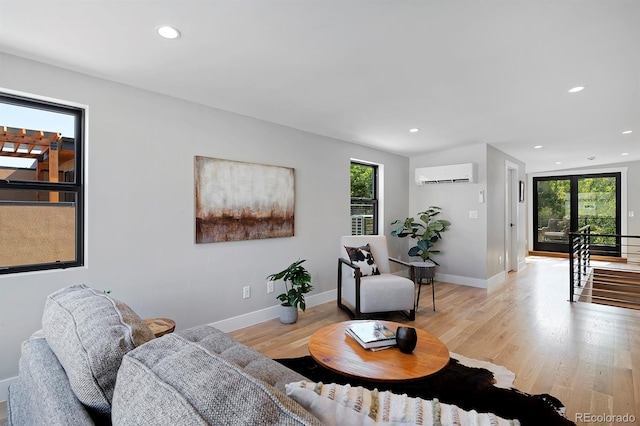 living room featuring light hardwood / wood-style floors and a wall mounted air conditioner