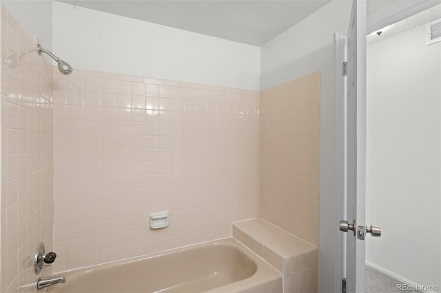 bathroom featuring  shower combination, baseboards, and visible vents